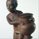 Nubian girl carrying a cosmetic jar, c. 1350 B.C. Boxwood with pigment and gold leaf. Oriental Museum, Durham University, U.K.